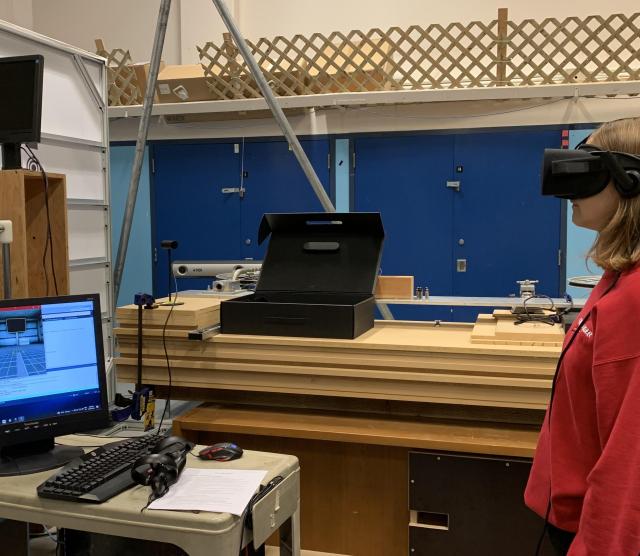 Lab with person in ed sweater wearing VR headset 